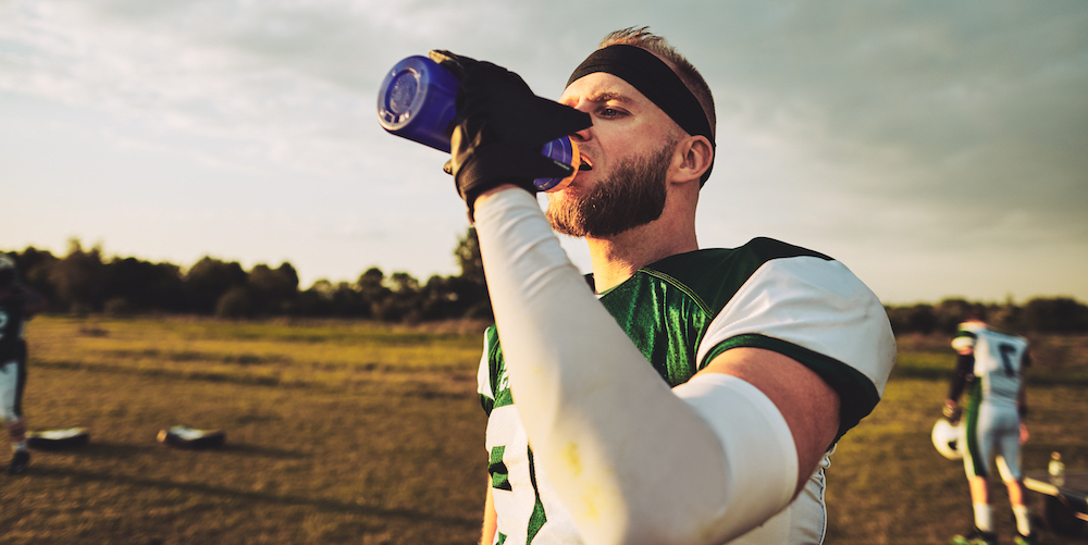 American,Football,Player,Drinking,From,A,Water,Bottle,While,Standing MX3 Sweat Sodium Test